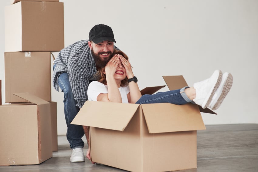 playful-mood-happy-couple-together-in-their-new-house-conception-of-moving